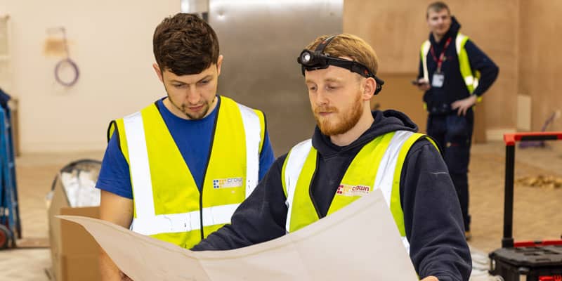 Crown Facilities staff looking at plans
